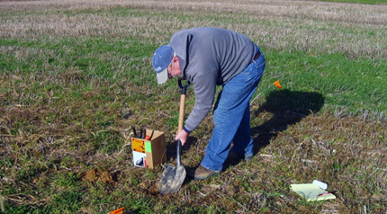 Jack Watson collects soil samples at Penn State