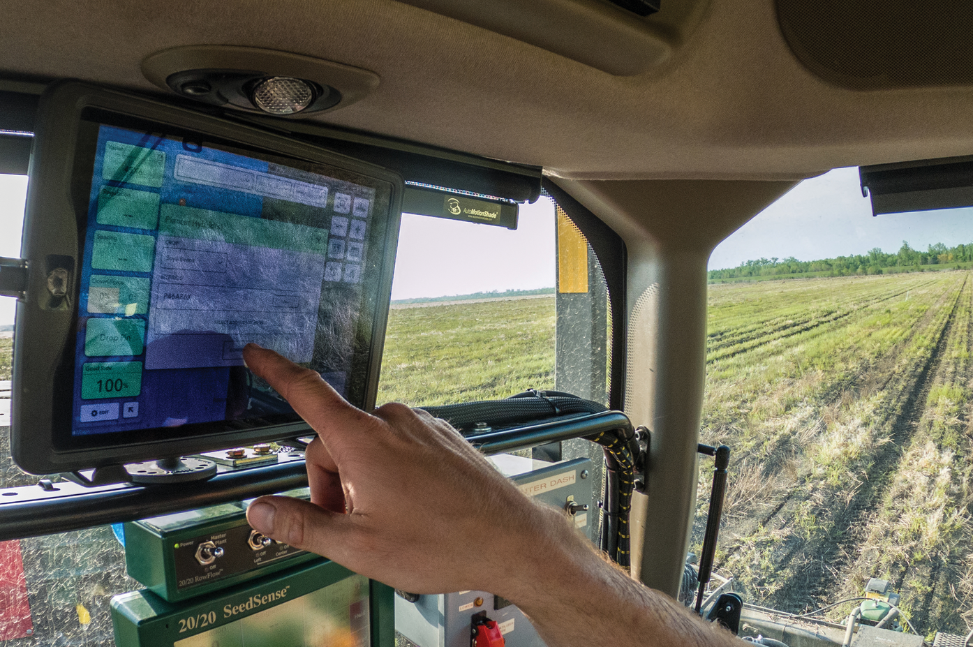 A farmer in a tractor/planter equipped with a planter monitor, a precision agriculture tool, to guide seed planting. Photo by Lance Cheung, USDA.