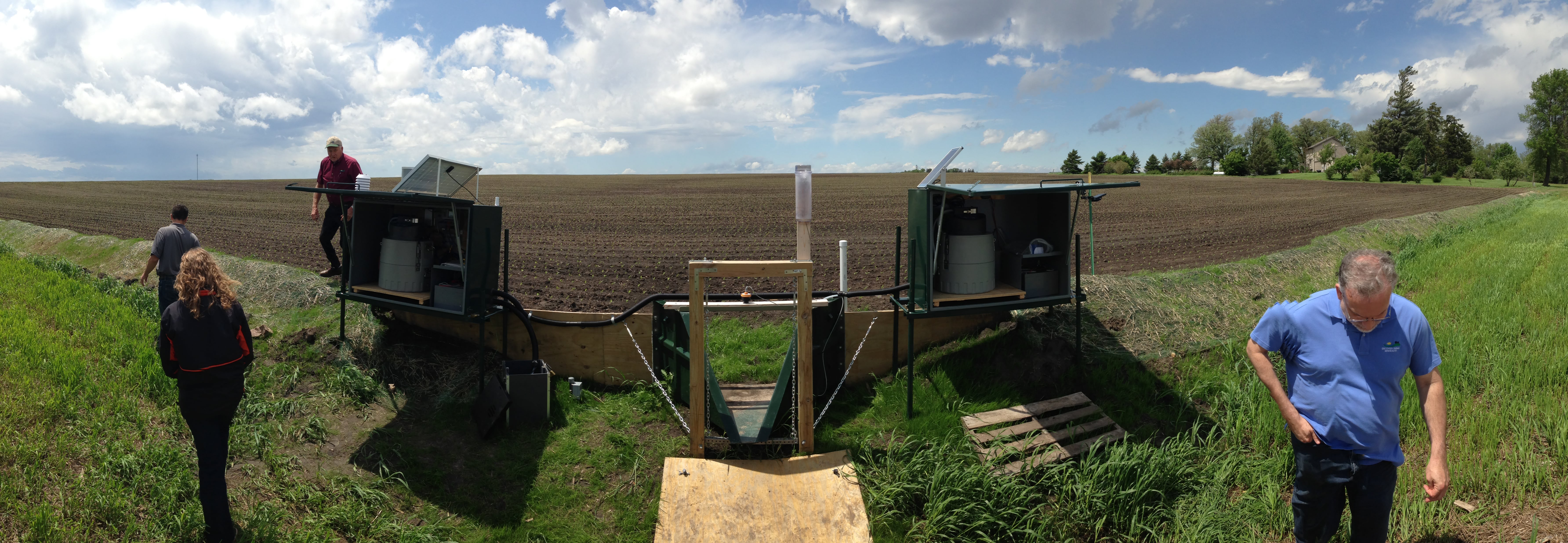 Fields are monitored using surface water and tile drainage monitoring stations, such as this one in Dodge County, Minnesota. Automated monitoring equipment is shown in the green boxes. Photo by Tim Radatz.