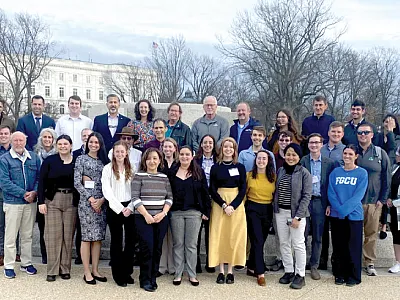 Congressional Visits Day attendees pose for a group photo near the U.S. Capitol in March. They represented 23 states and conducted 63 meetings with congressional offices.