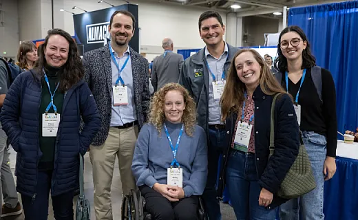 group of attendees smiling at camera from CANVAS event