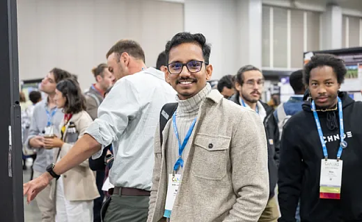 smiling attendee from CANVAS looking at camera